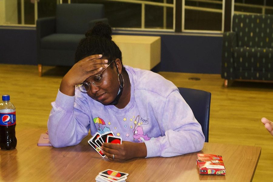 Azaria Bell, a sophomore communications disorders and sciences plays Uno at the Freshman Connection game night on Friday in the Lawson Hall lobby. 