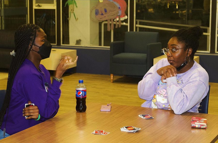 Azaria Bell, a sophomore communications disorders and sciences major, and Olutoyike Omokaiye, a freshman biology major, play Uno in the Lawson Hall lobby as part of the Freshman Connection Game night Friday.