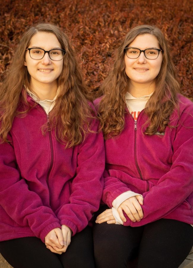 Ashley Mlinar and her twin sister, Haley Mlinar pose for pictures outside of Buzzard Hall on Mar. 3, 2022, at Eastern Illinois University in Charleston, Ill.