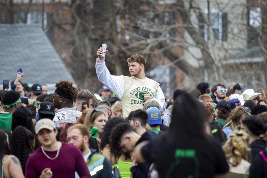 A student raises a black cherry White Claw at the second house on the Unofficial 2022 crawl. Unofficial is an annual event in Charleston where participants take part in a “house crawl” where people go from house to house drinking and partying. Unofficial is not affiliated with EIU.