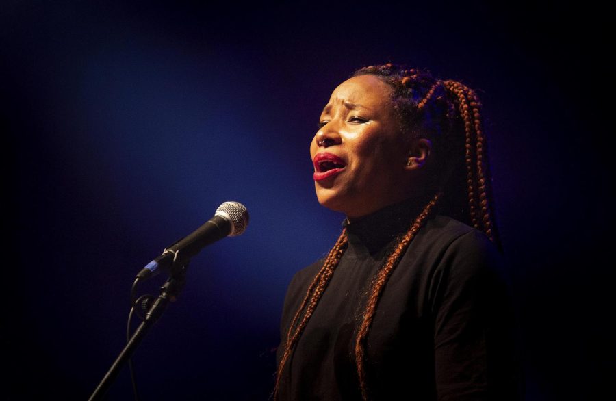 Aja Black, vocalist and emcee for The Reminders sings the final song in the performance “Coming Home” in the Dvorak Concert Hall Thursday. 