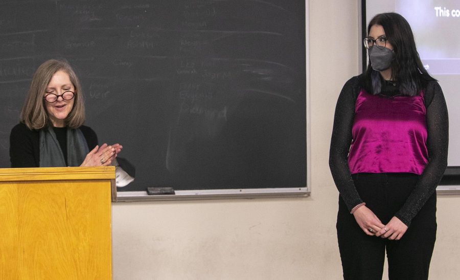 From left, Julie Campbell , an English professor, congratulates Kristen Paape, a studio 2D art major, on winning an award for her artistic work depicting queer stories and womens stories on Wednesday nigh in the Coleman Hall auditorium. Paape added, I was just really excited to apply it at all. And when I heard that, like feedback, specifically when they werent telling me like their comments up on stage, it was just like really fun for me and made me feel really good.