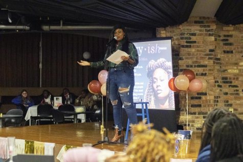 Crystal Valentine, the guest speaker for the Poetry-ish Women’s History Month event, reads her poem about how the Kardashian family culturally appropiate Black women on Thursday night in Martin Luther King Jr. University Union.