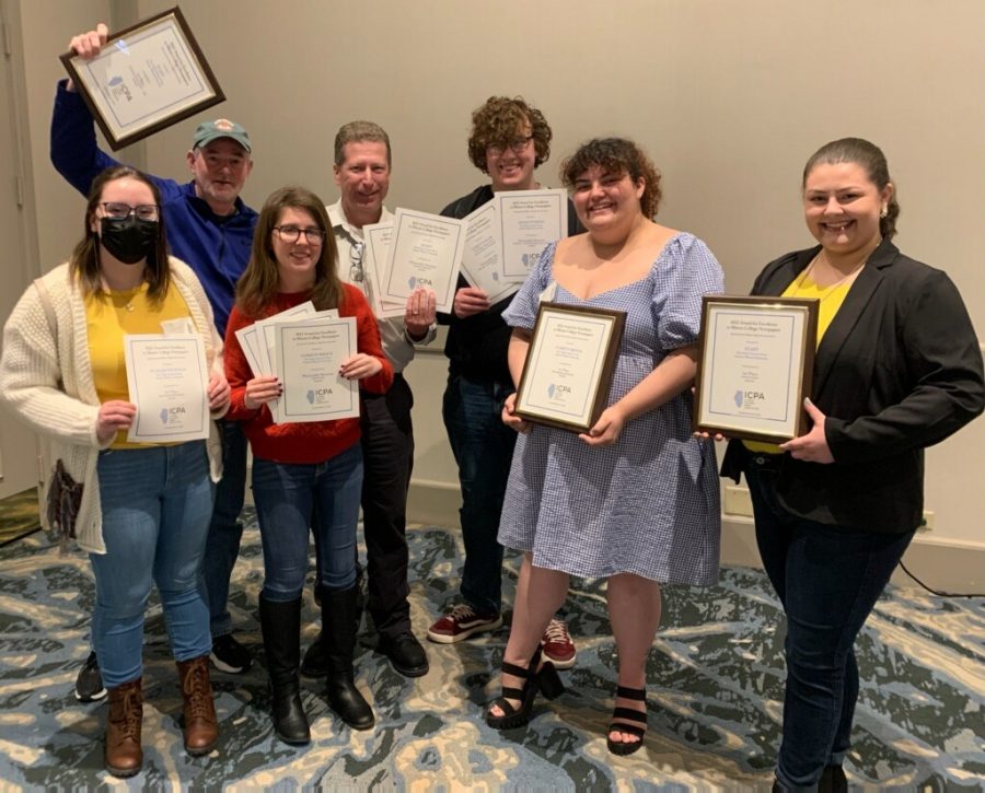 Members  and advisers of The Daily Eastern News pose with awards they won from the annual Illinois College Press Association contest.