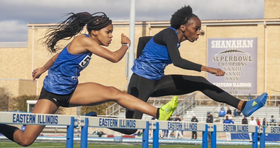 Eastern sophomores Akiya Kollore (right) and Shanisa Stinson jump side-by-side while competing in the womens 100 meter hurdles at the EIU Big Blue Classic held at OBrien Field on April 1. Kollore placed first with a time of 14.21 and Stinson came second at 14.33. 