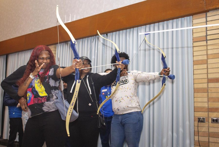 From left, Kiyara Watts, a sophomore management major, Anita McBride, a sophomore health administration major, and DeSean Hill, a computer information and technology major, shoot foam-tipped arrows at Pantherbash Thursday night. 