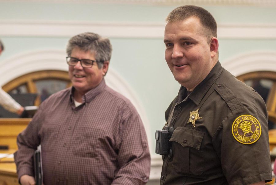 From right, Tyler Heleine, interim sheriff for Coles County, is congratulated by Coles County Board member Darrell Cox for being officially declared as interim sheriff at the end of the Thursday County Board meeting.