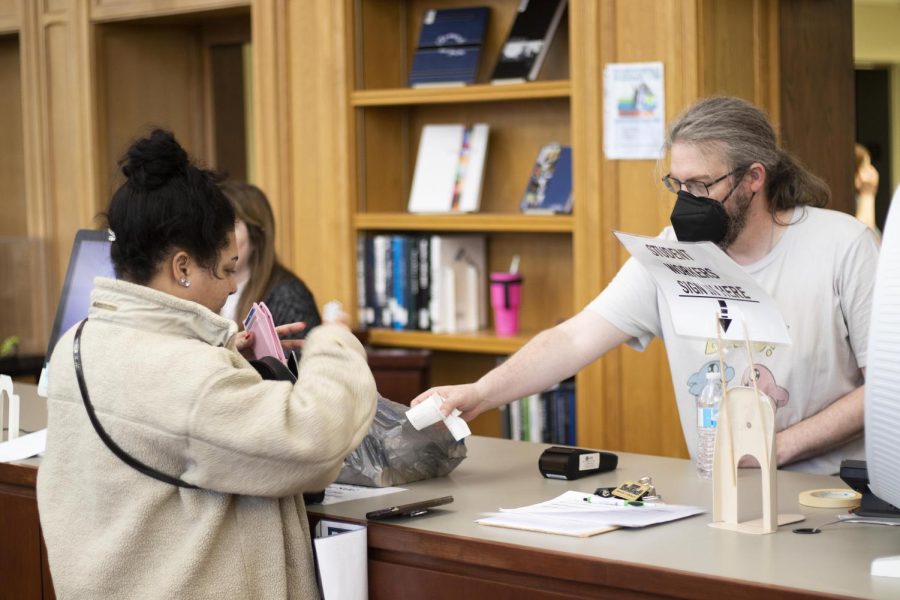 Madison Palmer, a graduate student and human services program admin, buys books from the Spring Book Sale on Wednesday afternoon in Booth Library.