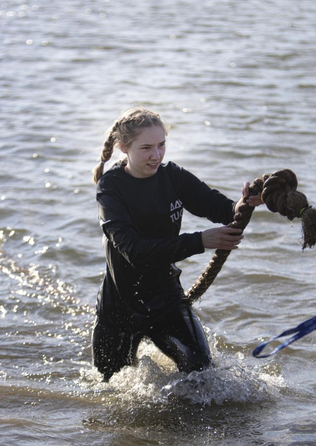 A member of the Tri Delta Sorority Inc., helps get a stranded rope out of the water at the Tugs event for Greek Week on Monday evening at the Campus Pond.