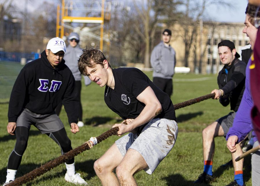 Miller Dunlap, a freshman with an undecided major, and member of Sigma Pi Fraternity Inc., helps his team win a victory for the Tugs competition event for Greek Week on Monday evening at the Campus Pond on April 18, 2022 at Eastern Ilinois University in Charleston, Ill.