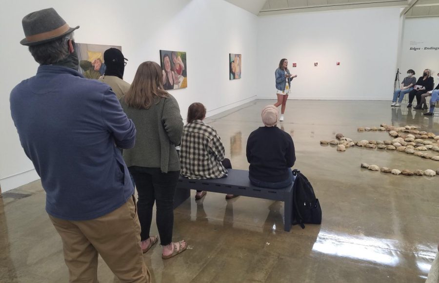 Emma Kamerer, a graduate student studying art, gives a presentation on her oil paintings during a Noontime Talk event hosted by the Tarble Arts Center on Friday. Kamerer is one of 13 graduate students that have work on display as part of the 2022 EIU Masters of Arts in Studio Art Exhibition. 