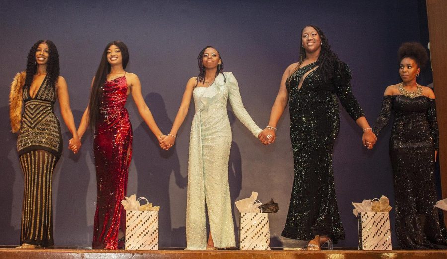 Miss Black and Gold Scholarship Pageant contestants from left, Tykyla Crockett, a senior human services program administration, Ariel Johnson, a sophomore pre-medicine major, Mia Smith, a sophomore health administration major, Daisha Mitchell, a sophomore health administration major, and Faith Johnson, a junior pre-physical therapy major, hold hands as they announced awards for the pageant Saturday night at the Grand Ballroom.