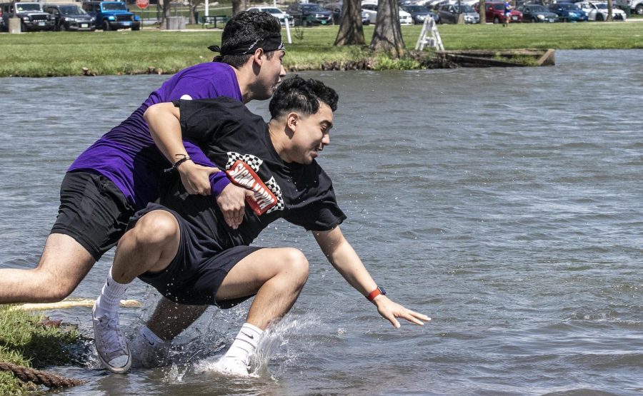 Members of Sigma Phi Epsilon celebrate their first place victory in the tugs finals by jumping into the Campus Pond Saturday afternoon.