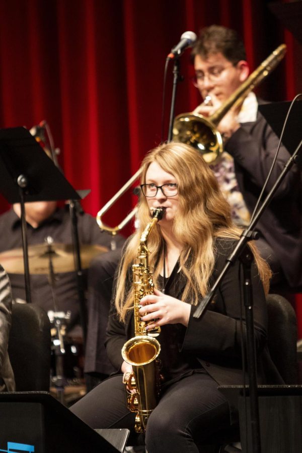 Kirsten Hetzel, a sophomore music teacher education major and an alto saxophone player,  follows the cues of the director, Sam Fagaly, during the Jazz Ensemble show on Tuesday night in Doudna Fine Arts Center.