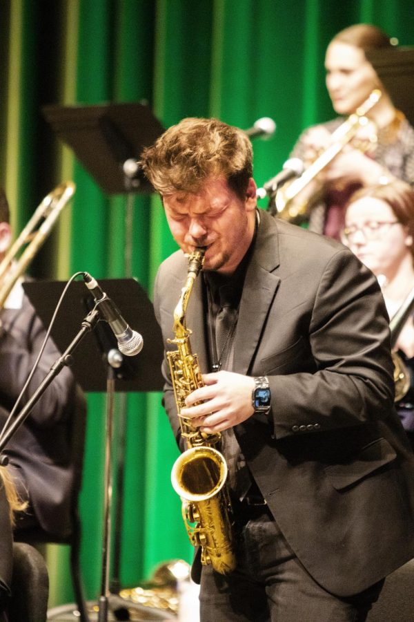 August Frisby, a music performance major and alto saxophone player, performs a solo during the Jazz Ensemble performance on Tuesday night in Doudna Fine Arts Center.