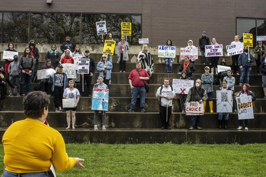 Atlas Hennegan, a senior English major, delivers a speech to the crowd during the Defend Roe! Emergency Rally at the Mellin Steps Thursday afternoon. Hennegan and several other speakers encouraged protesters with chants and offered personal stories. 