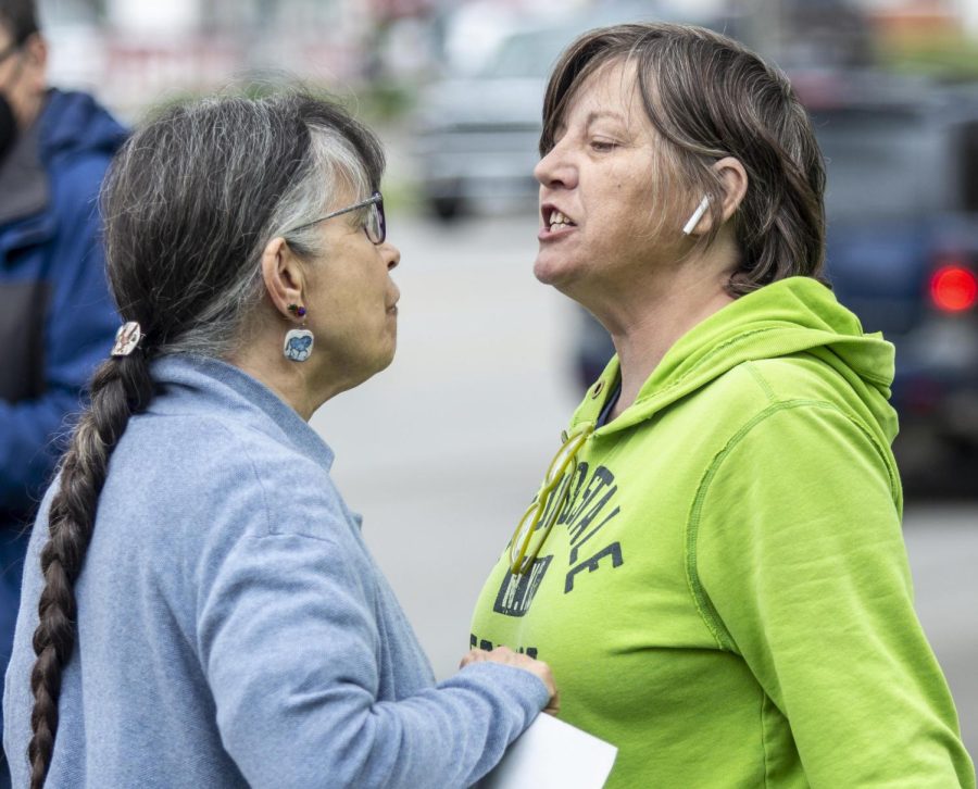 From left, Ruth Riegal listens to Bridgette Price argue about pro-choice ideas during the protest at Morton Park on Lincoln Ave. Friday at noon. The heated discussion ended with an exchange of words and a few unkind hand gestures. 