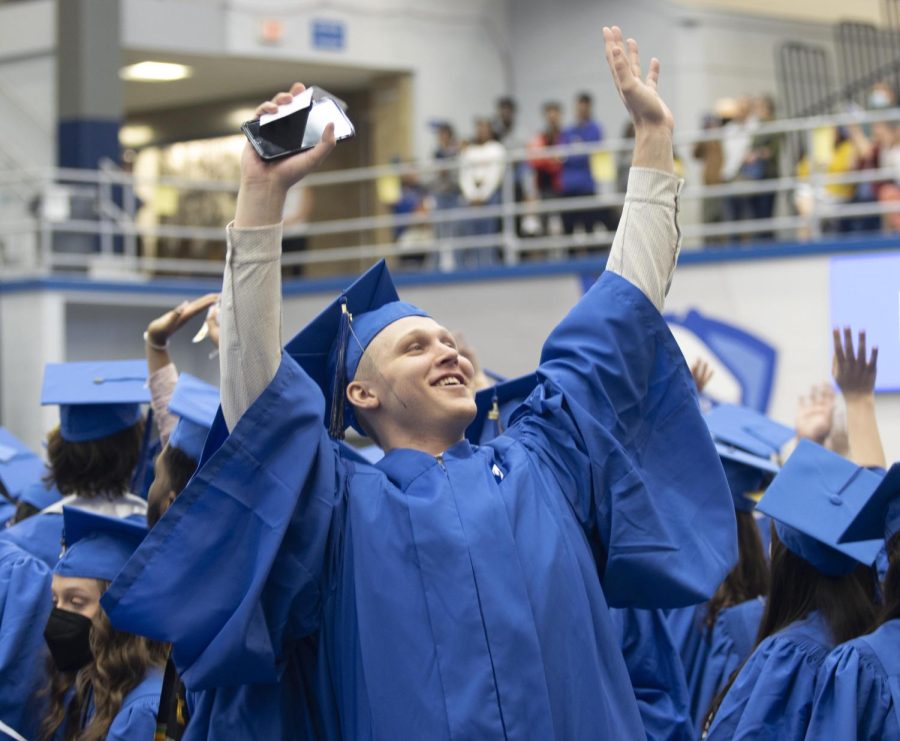 A graduate of the Eastern class of 2022 wave and acknowledge family and friends before the start of the commencement ceremony Saturday afternoon in Lantz Arena.