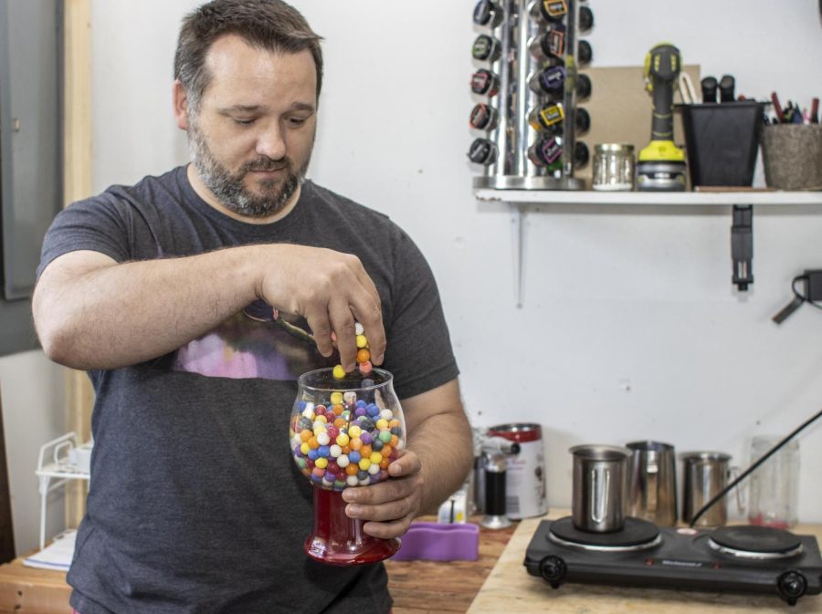 Dennis Malak shows off one of his long term projects, his gumball machine candle. He found an old gumball machine and he decided to mold little gumballs out of scraps of wax. Once he fills up the candle, he wants to fill the candle with clear wax.