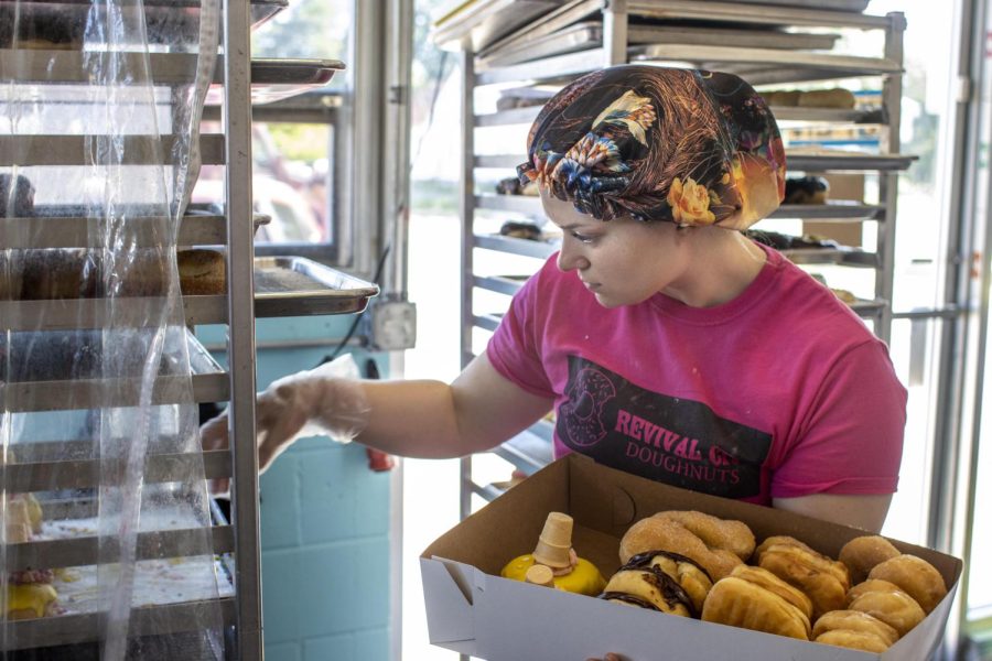 Employee Skylar Vickery, fills an order, during National Doughnut Day at Revival City Doughnuts Friday morning. Vickery said the personal connection is very welcoming and she it's why she loves working there.