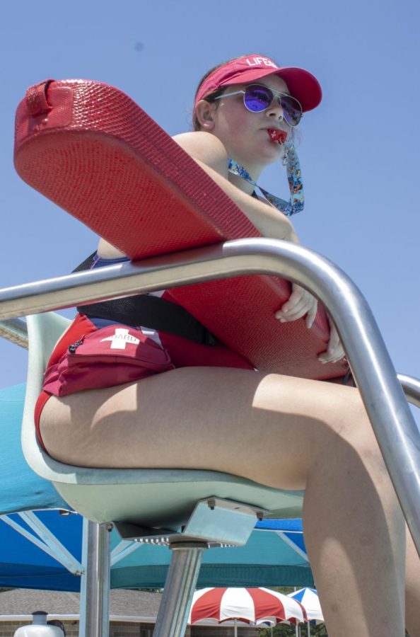 Gabrielle Fairchild watches the water while lifeguarding at the Rotary Community Aquatic Center on Tuesday. Fairchild has worked as a lifeguard for two summers and said she likes to do it because she likes to help others and be around people. 