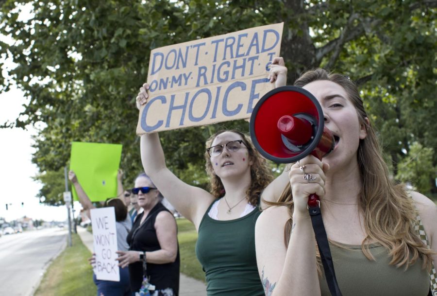 Siobhan Doherty speaks into a megaphone while protesting the overture of the Supreme Court Case Roe v. Wade Friday evening at Morton Park on Lincoln Ave. Doherty said she came out because she is very mad about Roe v. Wade being overturned. Im mad for not only myself, but also for all the women and people with uteruses that this is going to affect, Doherty said.