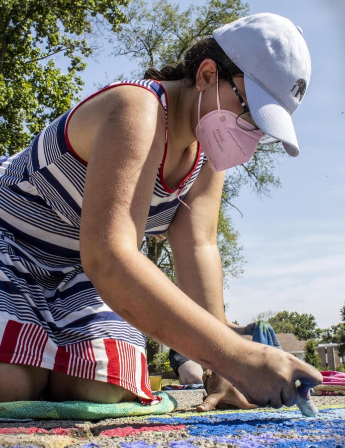 Charleston resident, Keshan Miller, draws an apple pie and fireworks for the Most Patriotic category during the Chalk-In event during Red, White and Blue Days on Monday in Morton Park. Miller said although her apple pie wasnt turning out how she wanted, she had a lot of fun. Typically she paints with water colors, but had more fun than she thought using chalk.