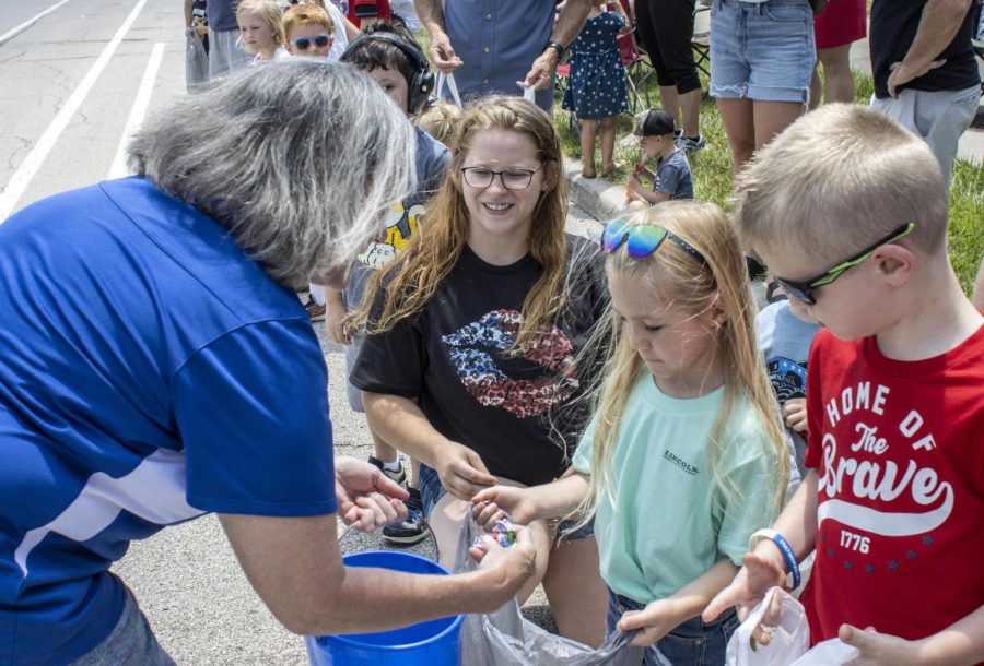 An individual sponsoring Melissa Hurst for Coles County Circuit Clerk, hands out candy to children during the Charleston Fourth of July parade Monday.