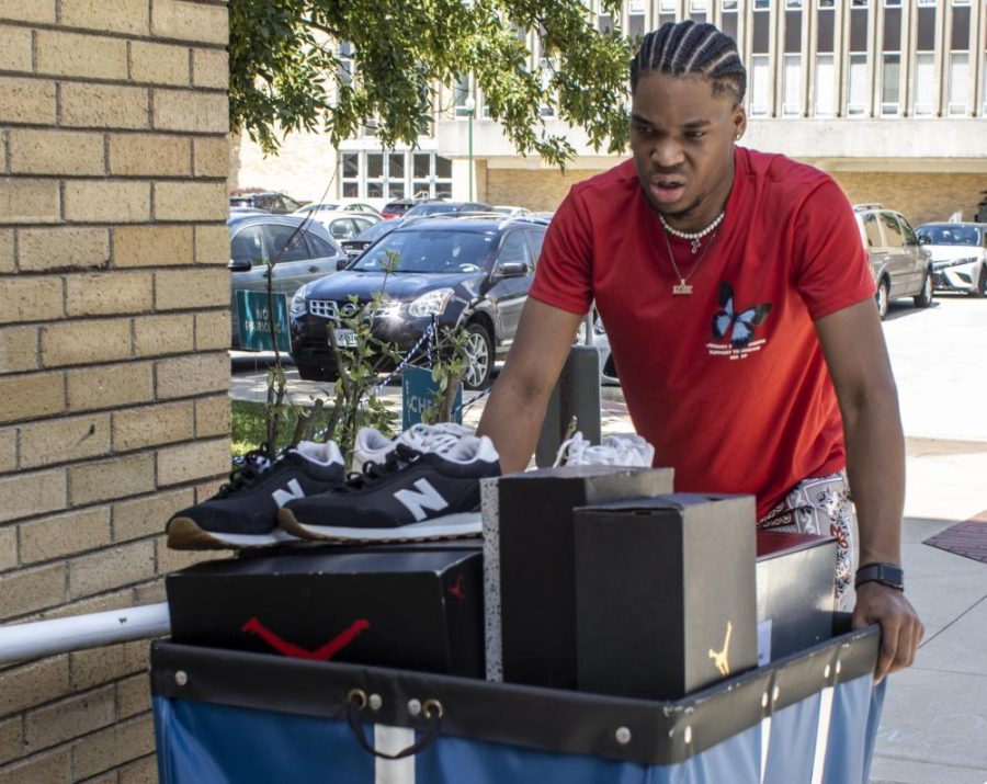 Lugging multiple totes into Taylor Hall on Friday afternoon during Welcome Weekend with his parents Kobe Jones, a sophomore accounting major, said he is excited for the new semester. He said he hopes to meet new friends and is looking to get involved in campus life. 