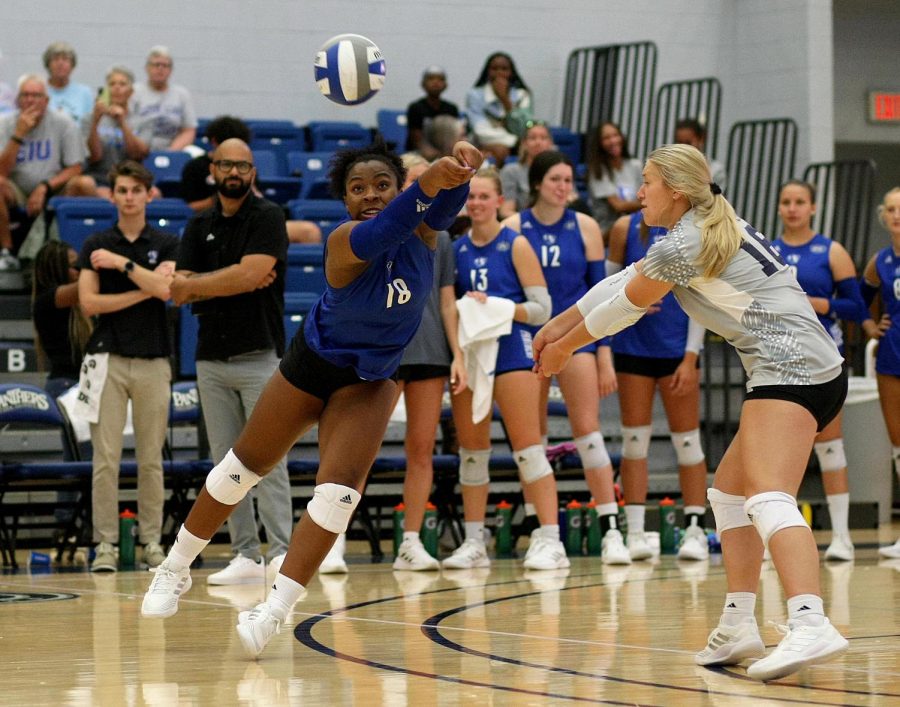 Number 18 TaKenya Stafford, a sophomore outside hitter dives to bump a ball during their exhibition game against University of Missouri- St. Louis on Saturday afternoon at Lantz Arena.