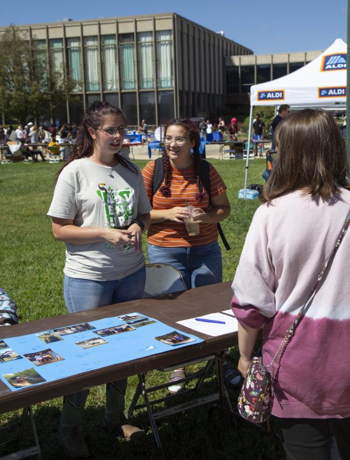 Maddy Allen, a therapeutic recreation and psychology major, and Rosa Mitofsky, a sophomore criminology major, talk to students who seem interested in the equestrian team during Pantherpalooza.