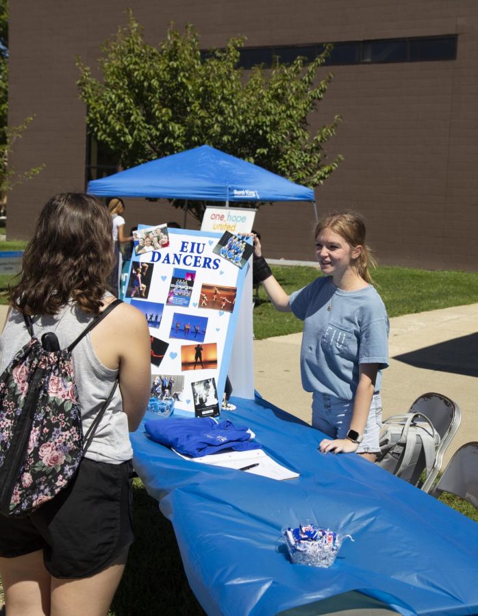 Mandy Transon, a junior early childhood special education major, who is apart of the dance team, informs students about EIU Dancers at Pantherpalooza on the Library Quad.