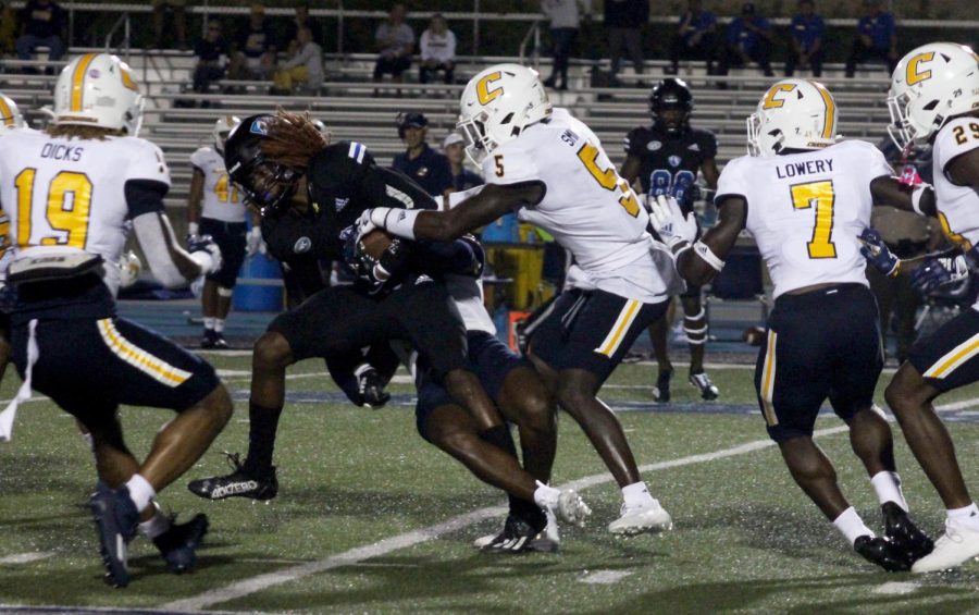 DeWayne Cooks Jr, a redshirt junior wide reciever, is tackled by the University of Tennessee- Chattanooga players during the Panthers first home game of the 2022 season on Saturday evening at OBrien Field. The Panthers lost 38-20 to the Mocs. Cooks Jr. ran for 24 yards with 2 recieves.
