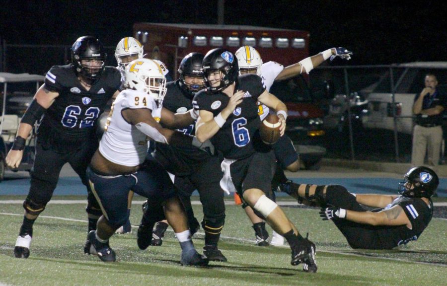 Jonah OBrien, a redshirt sophomore quarterback, runs through hole found in the University of Tennessee- Chattanooga Mocs defensive line during the fourth quarterthe Panthers first home game of the 2022 season on Saturday evening at OBrien Field. The Panthers lost 38-20 to the Mocs. OBrien completed 18-of-28 pass attempts, passing for a total of 183 yards with 2 touchdowns.