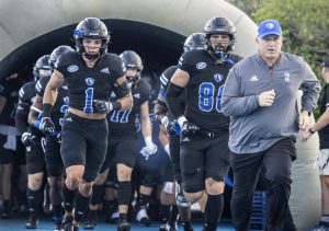 Eastern Illinois Universitys Head Football Coach Chris Wilkerson (front), runs out with players Jay Vallie (80), a graduate tight end, and Jordan Vincent (1), a sophomore safety, before the start of the Panthers first home game of the 2022 season Saturday evening at OBrien Field. The Panthers lost against the University of Tennessee- Chattanooga Mocs 38-20. 
