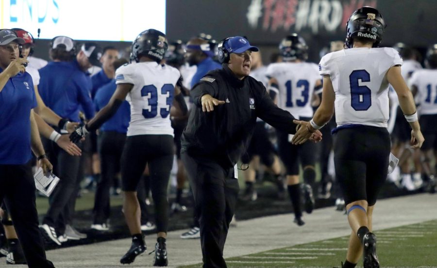 Eastern Head Football Coach Chris Wilkerson encourages Redshirt Sophomore Quarterback Jonah OBrien after scoring a touchdown in the third quarter of the season opener against Northern Illinois University at Huskies Stadium Thursday night. The Panthers lost 34-27 against the Huskies.