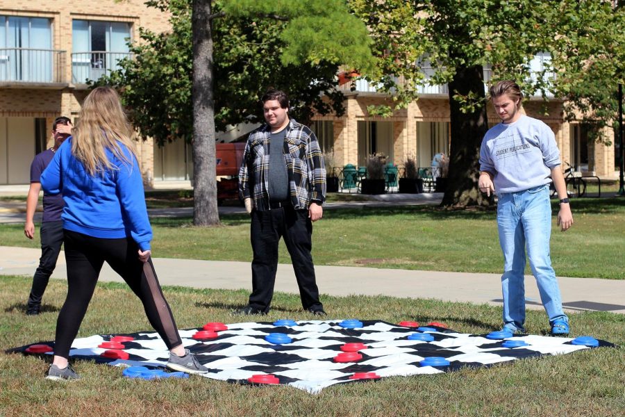 Students play giant checkers in the Library Quad for part of a Mental Health Pop Up Day event Tuesday afternoon.