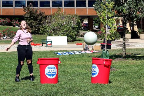 Katie Gillespie, a freshman secondary English education major chucks a ball while playing giant yard pong in the Library Quad for part of a Mental Health Pop Up Day event Tuesday afternoon.
