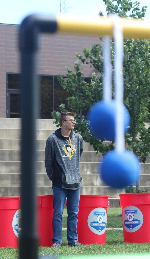 Dylan Meek, a freshman history education major, watches fellow students play giant yard pong in the Library Quad for part of a Mental Health Pop Up Day event Tuesday afternoon.