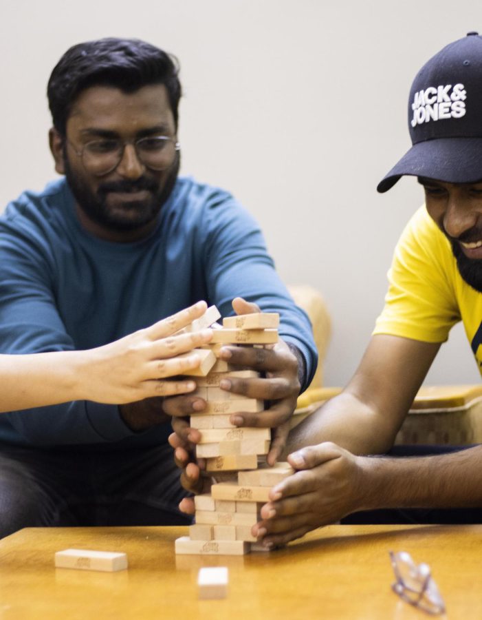 Arvind Kumar Bhongiri, a graduate student in computer technology, and Vishal Kadamanda, also a computer technology graduate student, try not to let the blocks fall while playing Jenga at Resident Hall Night in Booth Library on Wednesday.