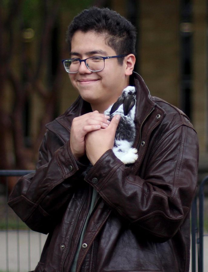 Emililo Zarata, a finance major, holds a Willow City Farm bunny at the Charleston Round Up Petting Zoo Friday afternoon in South Quad.
