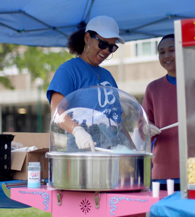 Attainea Toulon, a graduate student in the College of Student Affairs, makes blue raspberry cotton candy at the Charleston Round Up Friday afternoon in South Quad.