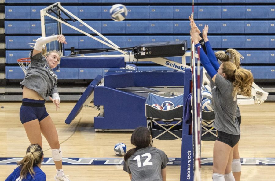 Kaitlyn Flynn, a sophomore outside hitter, spikes the ball during volleyball practice Tuesday afternoon at Lantz Arena .