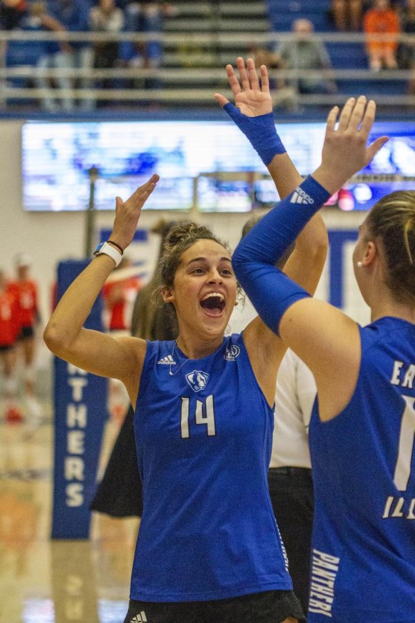 Number 14 Lilli Amettis, a freshman outside hitter and opposite hitter, dances in excitement with teammates after scoring a point during the volleyball game against the Illinois State University Redbirds at Lantz Arena Wednesday evening. The Panthers lost 3-0 to the Redbirds.