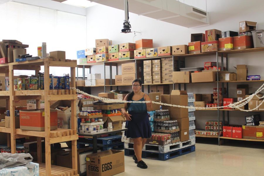 Victoria Tegge, a nutrition and dietetics graduate student, looks around in the food pantry inside McAfee Gym Friday afternoon.
