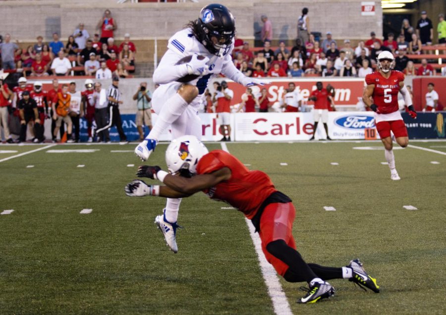 Justin Thomas, a senior wide receiver, leaps over Franky West, a sophomore defensive back, to avoid the tackle. The Panthers lost to the Redbirds 7-35 Saturday night at Illinois State University.