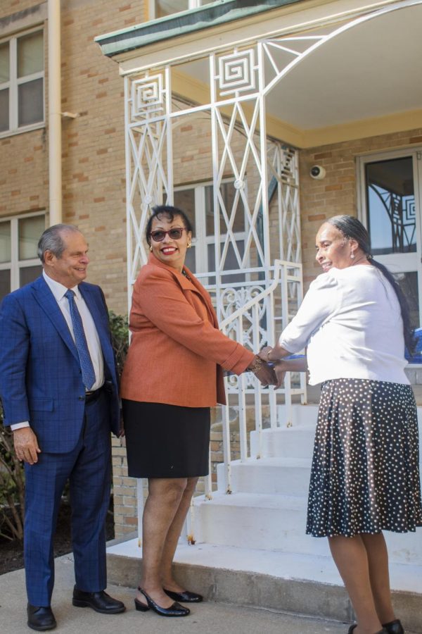 Stephanie Wright-Griggs and Carla Wright, two great granddaughters to Zella Powell, join together to cut the ribbon for Powell-Norton Hall in honor of its rededication on Friday afternoon.