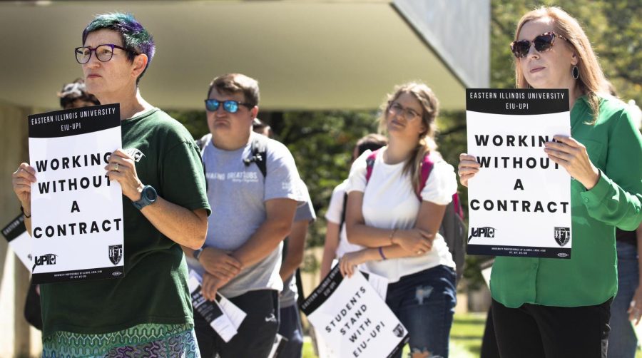 Jeannie Ludlow, professor of English and director of womens gender, and sexuality studies, and Jennifer Stevens, the associate professor of sociology and criminology, listen to faculty speak to their audience as the Teach Out ends on the Library Quad Thursday afternoon.                                                                                                                                                                                                                                                                                                                                                                                                                                                                                                                                                                                                                                                                                                                                                                                                                                                                                                                                                                                                                                                                                                                                                                                                                                                                                                                                                                 