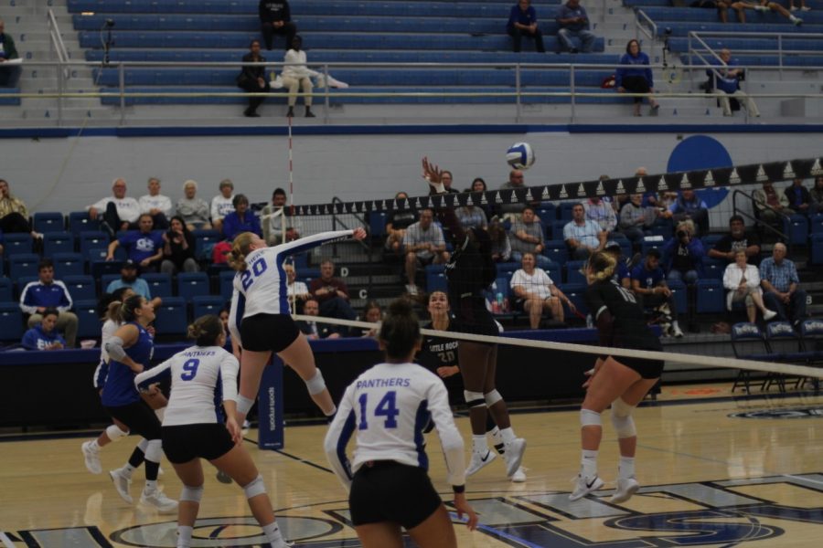 Number+20+Emily+Wilcox%2C+a+junior+middle+blocker%2C+hits+the+ball+over+the+net+during+the+volleyball+game+against+the+University+of+Arkansas-+Little+Rock+Trojans+Friday+evening+at+Lantz+Arena.+Wilcox+had+3+spikes+and+4+kills%2C+scoring+7.5+points.+The+Panthers+won+3-0+against+the+Trojans.