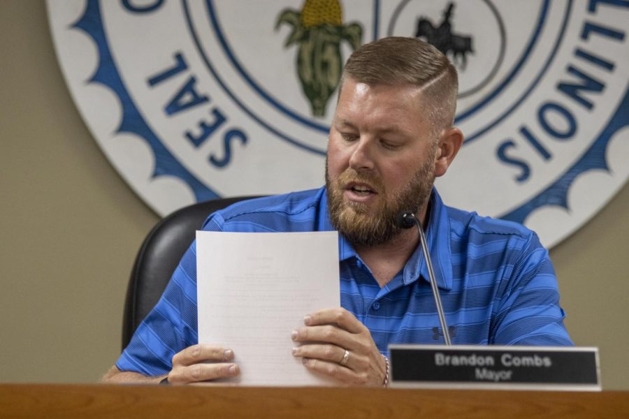 Charleston Mayor Brandon Combs stacks his papers while after reading an ordinance for regulating low-speed gas-powered bicycles during the City Council meeting Tuesday evening at City Hall.